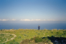 Jeremy, on the edge of a cliff, and a stone circle at Les Ruines d'Occi