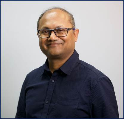 A person wearing glasses and a blue shirt

AI-generated content may be incorrect.